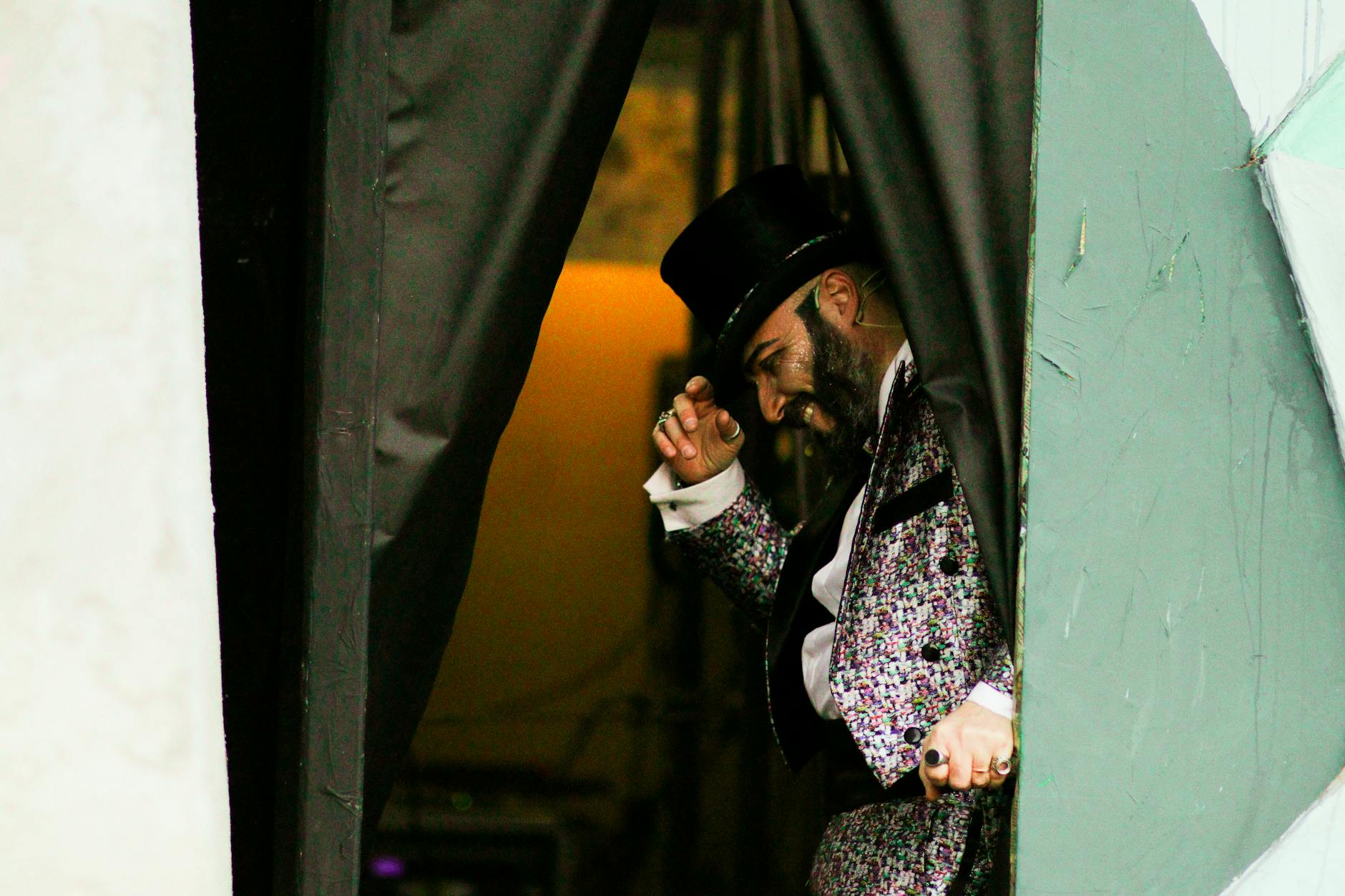 smiling man in circus suit and hat
